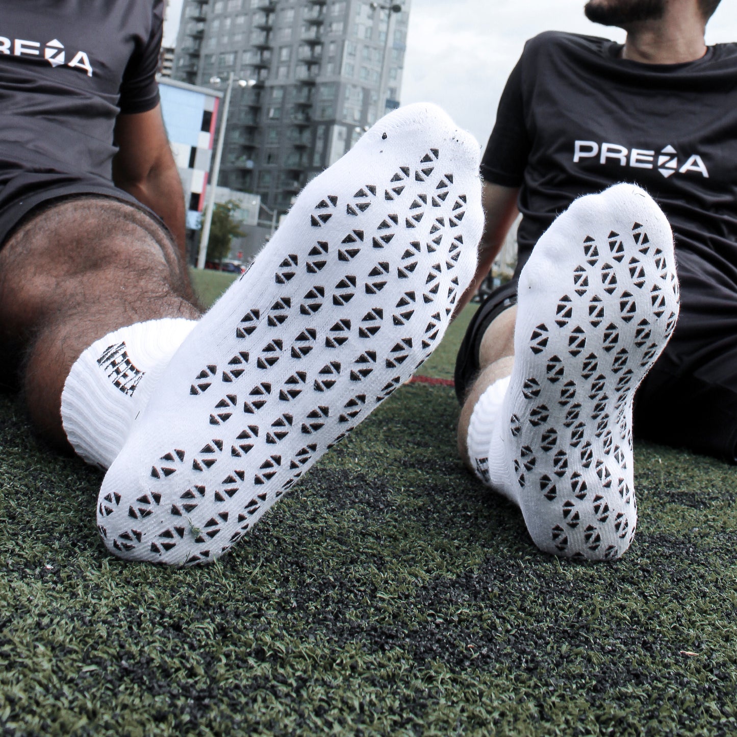 White Preza Grip sock on two models showcasing the underneath grip.