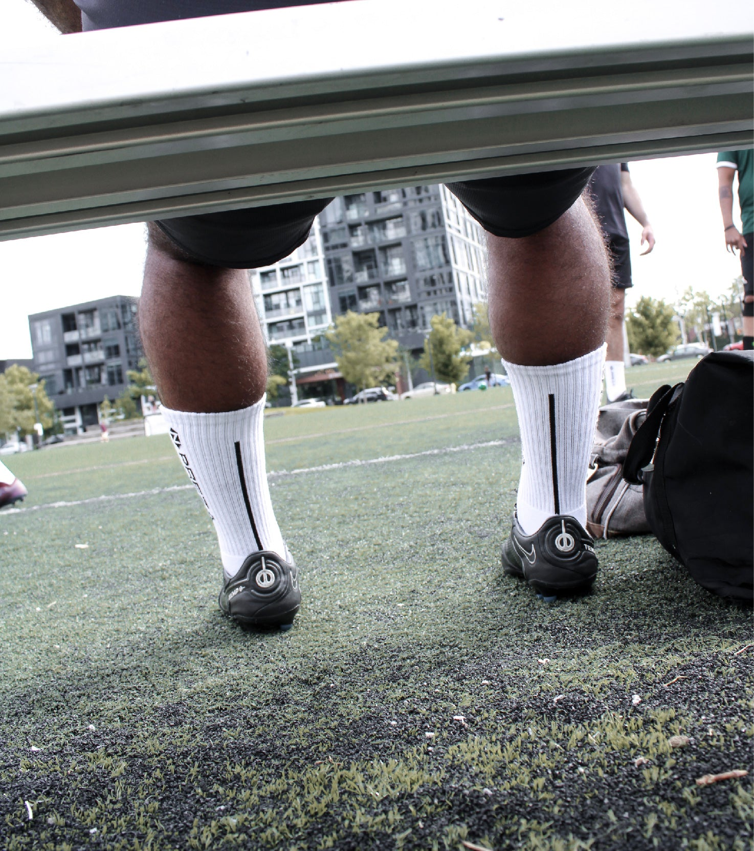 Model sitting and showcasing the back of a Preza Grip Sock